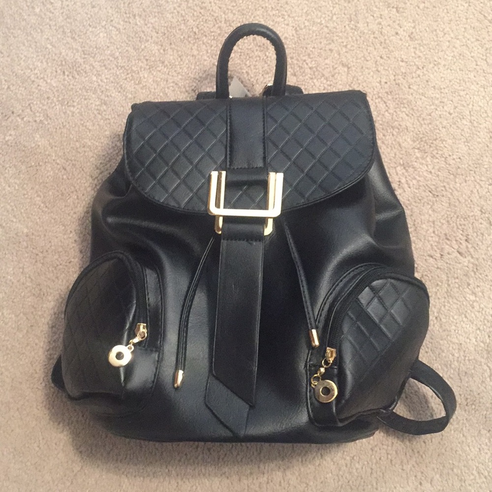 Brand new black faux leather backpack.